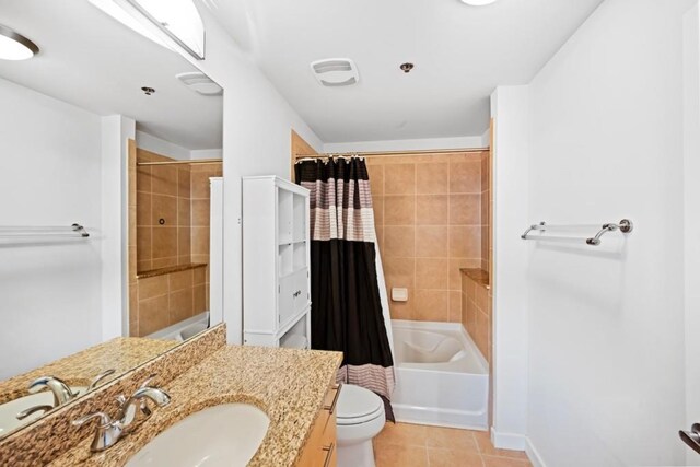 full bathroom with tile patterned flooring, vanity, toilet, and shower / bathtub combination with curtain