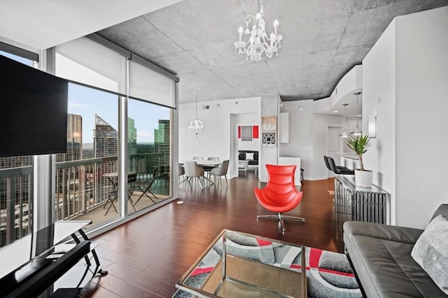 living room featuring a notable chandelier, hardwood / wood-style flooring, and expansive windows