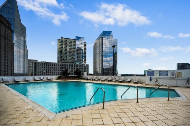 pool featuring a view of city and a patio