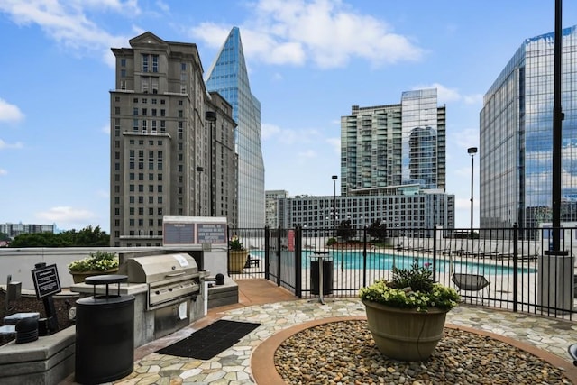 view of patio featuring area for grilling, a community pool, and grilling area