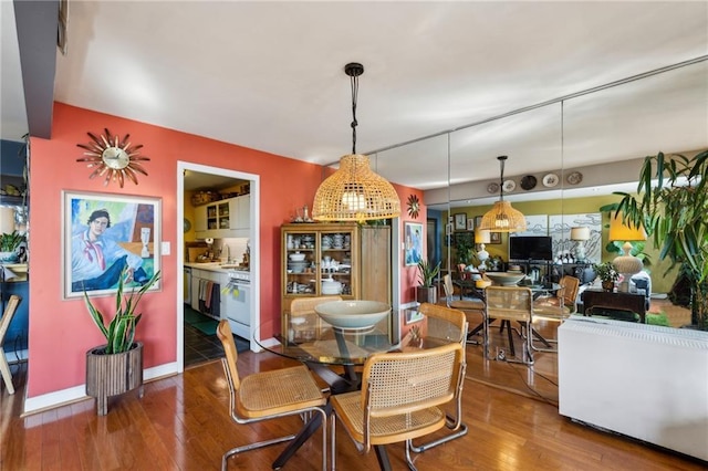 dining space with hardwood / wood-style floors