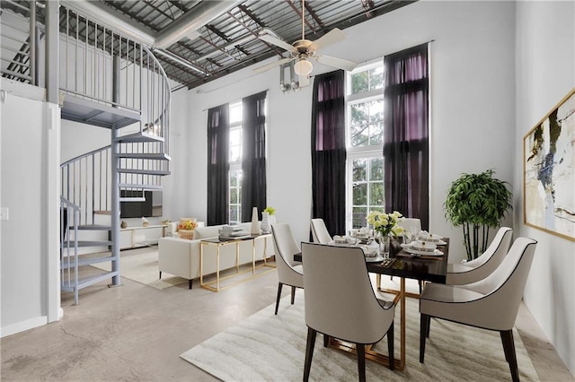 572 Edgewood Ave NE Unit 309, Atlanta, GA 30312 - dining room with concrete floors, ceiling fan, and a towering ceiling
