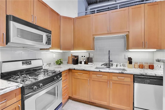 572 Edgewood Ave NE Unit 309, Atlanta, GA 30312 - kitchen featuring sink, decorative backsplash, light stone countertops, and stainless steel appliances