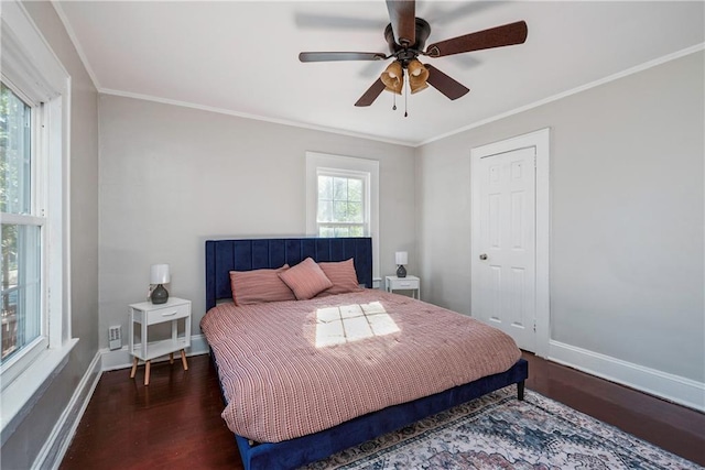 bedroom featuring dark wood-style floors, ceiling fan, crown molding, and baseboards