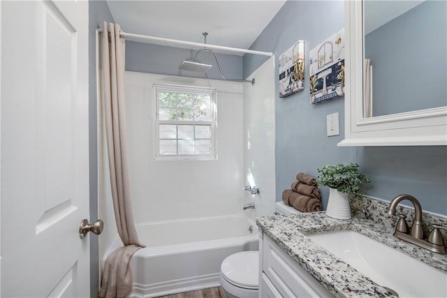 bathroom with shower / bath combo, vanity, and toilet