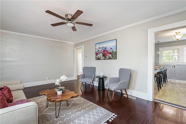 living room featuring visible vents, baseboards, dark wood-type flooring, and ornamental molding