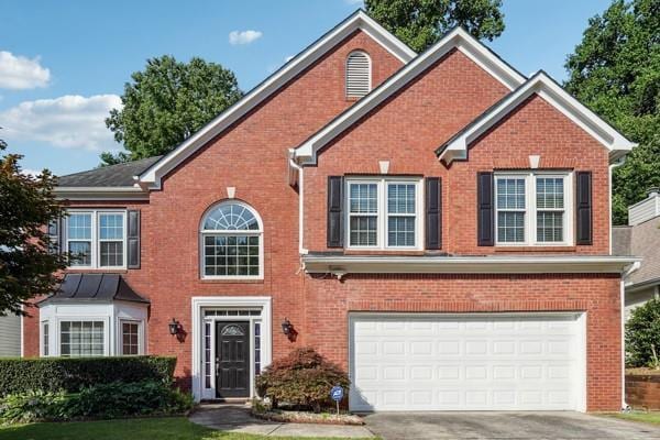 3272 Monarch Pine Dr, Peachtree Corners, GA 30071 - view of front facade with brick siding, driveway, and a garage