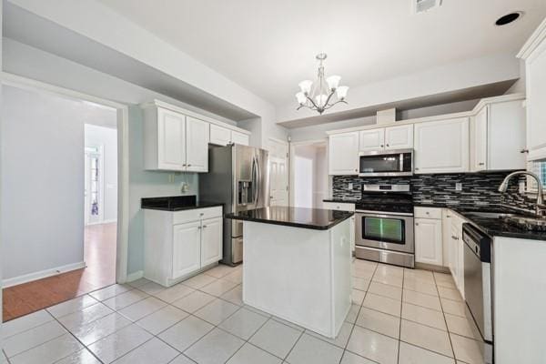 3272 Monarch Pine Dr, Peachtree Corners, GA 30071 - kitchen with appliances with stainless steel finishes, tasteful backsplash, a chandelier, and a kitchen island