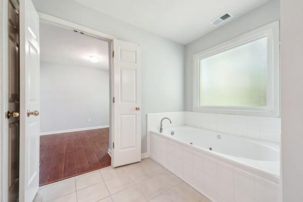 3272 Monarch Pine Dr, Peachtree Corners, GA 30071 - bathroom with a whirlpool tub and tile patterned flooring