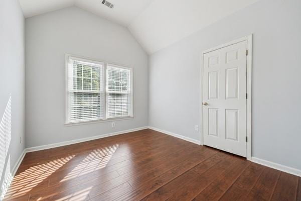 3272 Monarch Pine Dr, Peachtree Corners, GA 30071 - spare room featuring dark wood-style flooring and vaulted ceiling