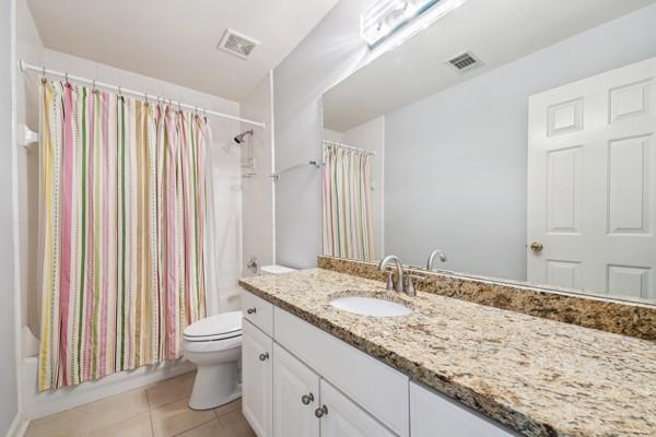 3272 Monarch Pine Dr, Peachtree Corners, GA 30071 - bathroom featuring tile patterned flooring, vanity, and shower / bath combo with shower curtain