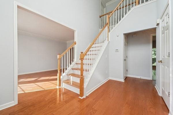 3272 Monarch Pine Dr, Peachtree Corners, GA 30071 - stairs with wood finished floors, ornamental molding, and a towering ceiling