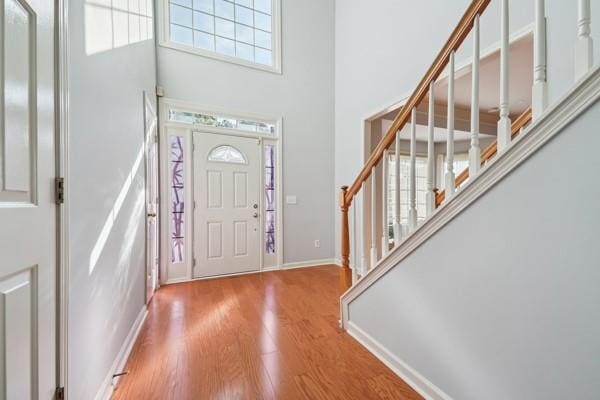 3272 Monarch Pine Dr, Peachtree Corners, GA 30071 - entryway featuring stairway, wood finished floors, and a towering ceiling