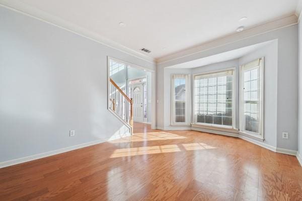 3272 Monarch Pine Dr, Peachtree Corners, GA 30071 - empty room featuring ornamental molding, stairs, and wood finished floors