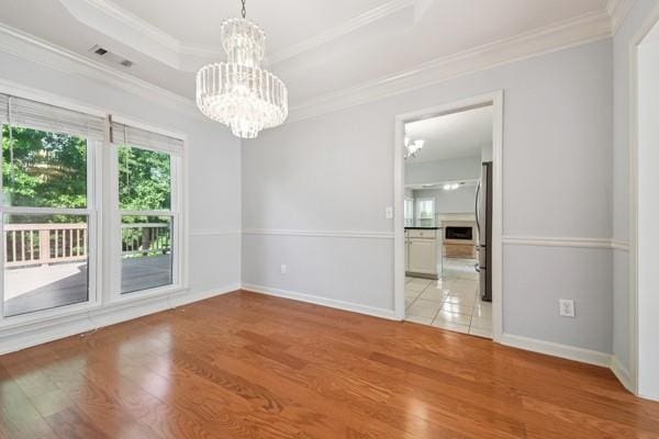 3272 Monarch Pine Dr, Peachtree Corners, GA 30071 - spare room with a chandelier, wood finished floors, and crown molding