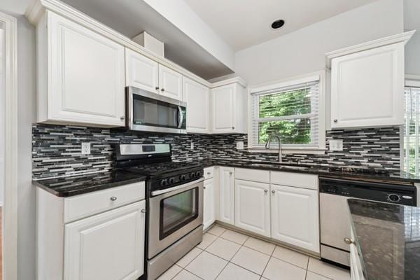 3272 Monarch Pine Dr, Peachtree Corners, GA 30071 - kitchen featuring appliances with stainless steel finishes, light tile patterned floors, and white cabinetry