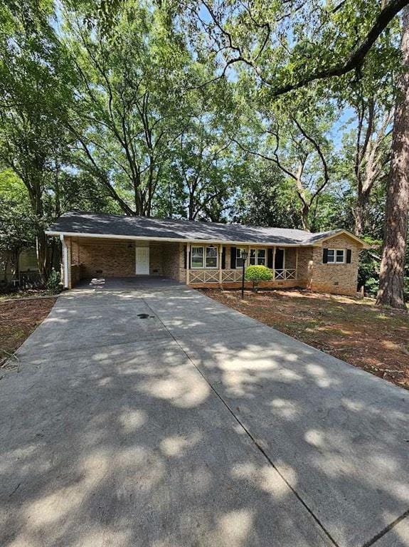 ranch-style home featuring concrete driveway and crawl space