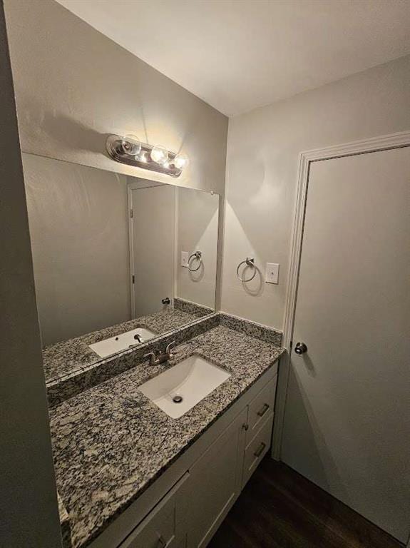 bathroom with vanity and wood finished floors