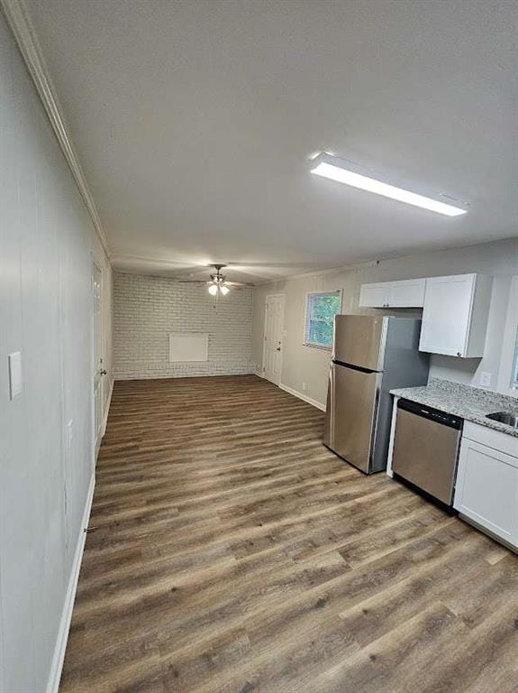 kitchen featuring dark wood-type flooring, white cabinets, appliances with stainless steel finishes, and a sink