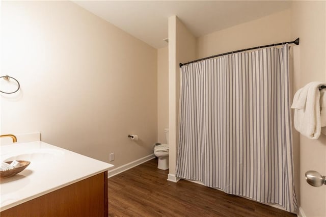 bathroom with vanity, wood-type flooring, and toilet