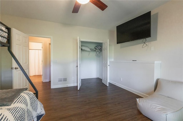 bedroom with ceiling fan, a closet, and dark hardwood / wood-style floors