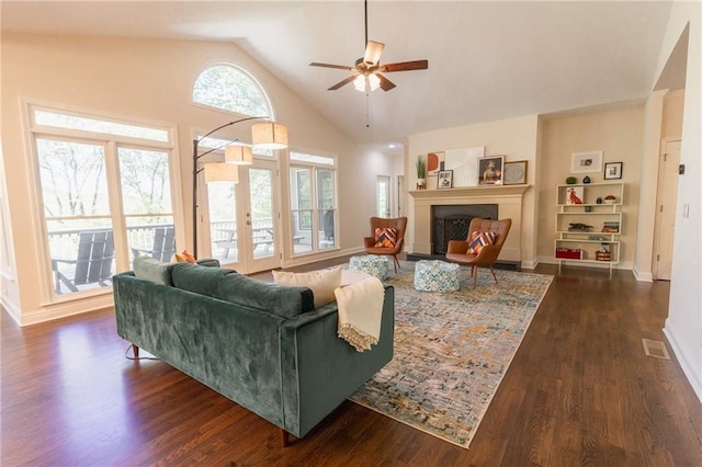 living room with dark hardwood / wood-style floors, ceiling fan, lofted ceiling, and french doors