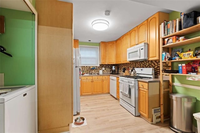 5400 Roswell Rd Apt L6, Sandy Springs, GA 30342 - kitchen with white appliances, washer / dryer, light wood-style flooring, and decorative backsplash