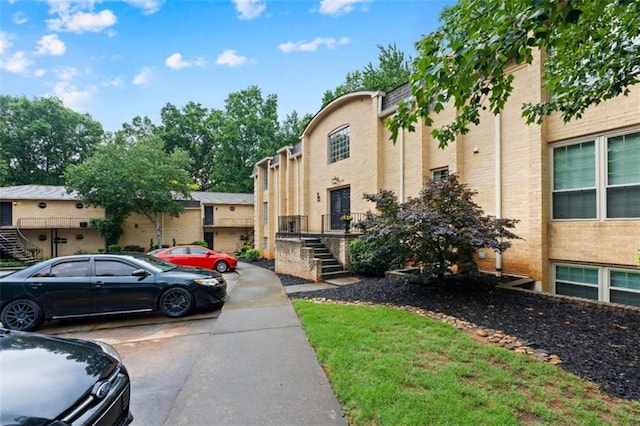 5400 Roswell Rd Apt L6, Sandy Springs, GA 30342 - view of front facade featuring stairs and uncovered parking