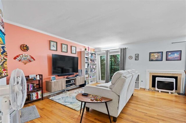 5400 Roswell Rd Apt L6, Sandy Springs, GA 30342 - living room with wood finished floors, crown molding, and a fireplace with flush hearth