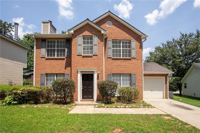 711 Ashley Ln, Stone Mountain, GA 30087 - view of front of house with a garage, concrete driveway, a front yard, and brick siding