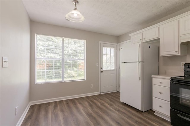711 Ashley Ln, Stone Mountain, GA 30087 - kitchen with black electric range, freestanding refrigerator, dark wood finished floors, white cabinetry, and a textured ceiling
