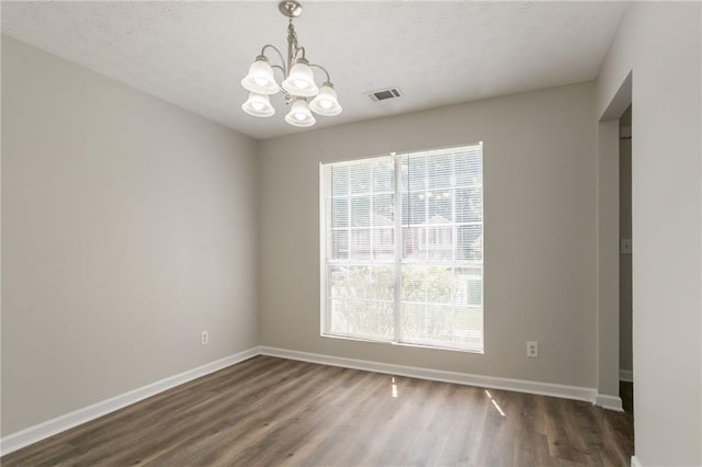 711 Ashley Ln, Stone Mountain, GA 30087 - empty room featuring a chandelier and dark wood-type flooring