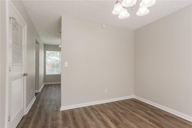 711 Ashley Ln, Stone Mountain, GA 30087 - spare room with a chandelier and dark wood-style floors