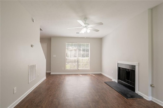 711 Ashley Ln, Stone Mountain, GA 30087 - unfurnished living room with a fireplace with raised hearth, dark wood finished floors, and ceiling fan