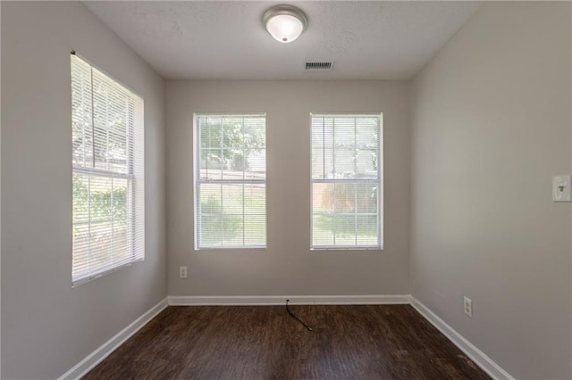 711 Ashley Ln, Stone Mountain, GA 30087 - unfurnished room with dark wood-style floors and healthy amount of natural light