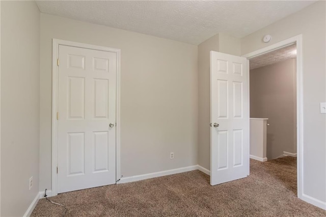 711 Ashley Ln, Stone Mountain, GA 30087 - unfurnished bedroom featuring carpet floors and a textured ceiling