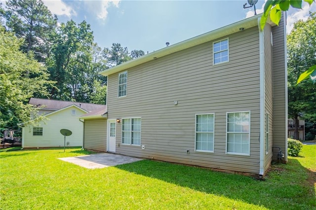 711 Ashley Ln, Stone Mountain, GA 30087 - back of house featuring a lawn and a patio