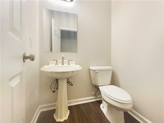 bathroom with wood-type flooring and toilet