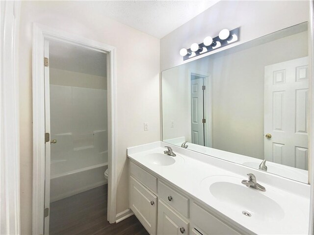 bathroom with vanity, hardwood / wood-style flooring, and toilet