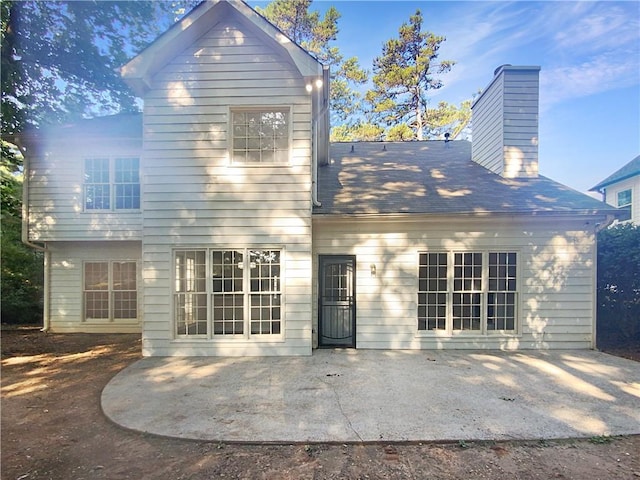 back of property with a patio