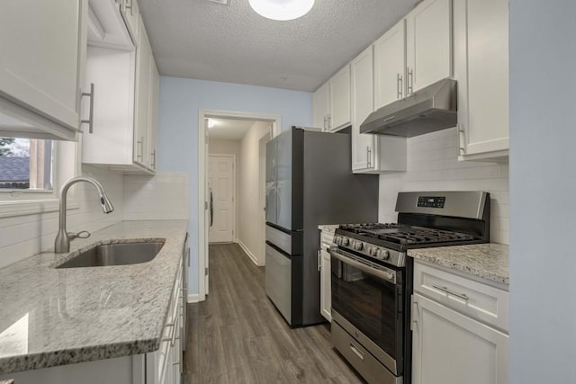 kitchen with sink, light stone countertops, a textured ceiling, gas stove, and white cabinetry