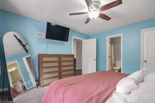 carpeted bedroom featuring a textured ceiling, connected bathroom, and ceiling fan