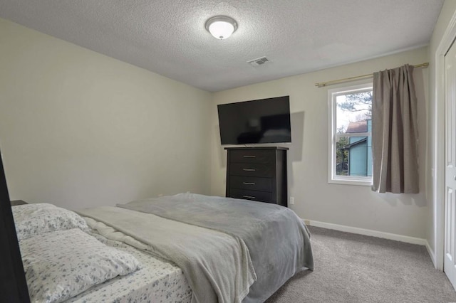 bedroom featuring carpet and a textured ceiling