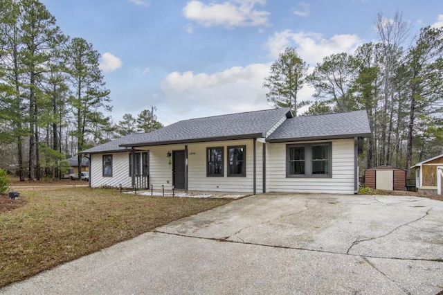 single story home with a storage shed