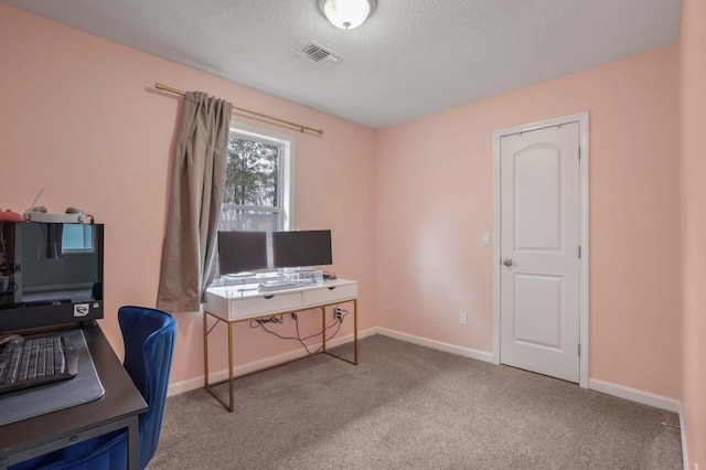 carpeted office space with a textured ceiling