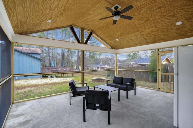 sunroom with ceiling fan, wood ceiling, and lofted ceiling