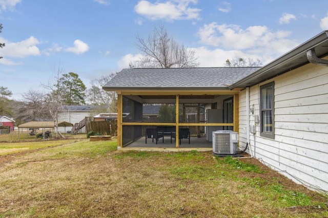 view of yard with a sunroom and central AC