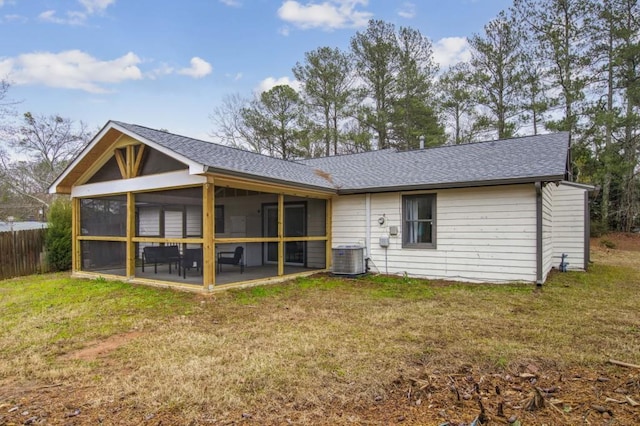 back of property with a lawn, a sunroom, and cooling unit