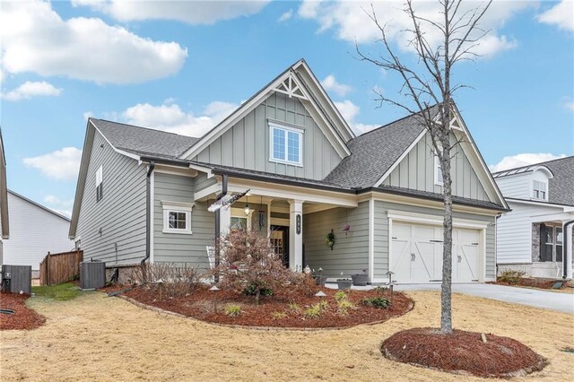 craftsman house with central AC unit and a garage