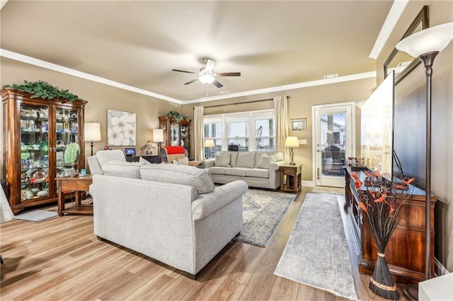 living room with ceiling fan, crown molding, and light hardwood / wood-style floors